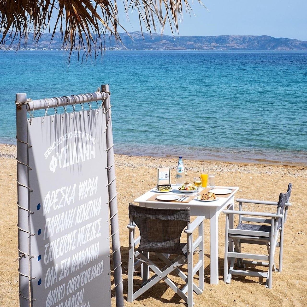The sandy shore and calm water of Logaras, the next cove along from Punda beach on the east coast of Paros