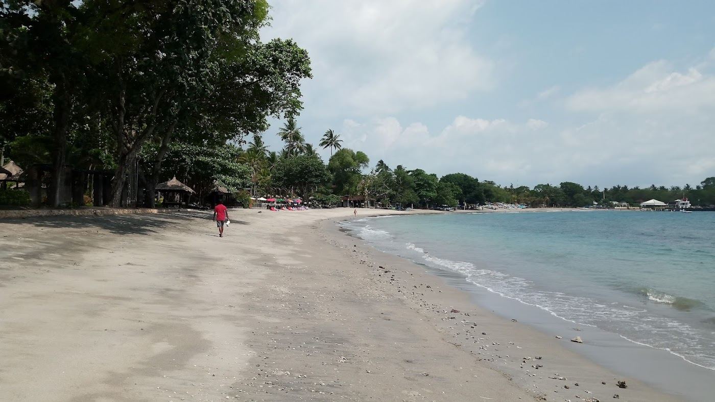 The dark volcanic sand and headlands of Senggigi beach on the west coast of Lombok