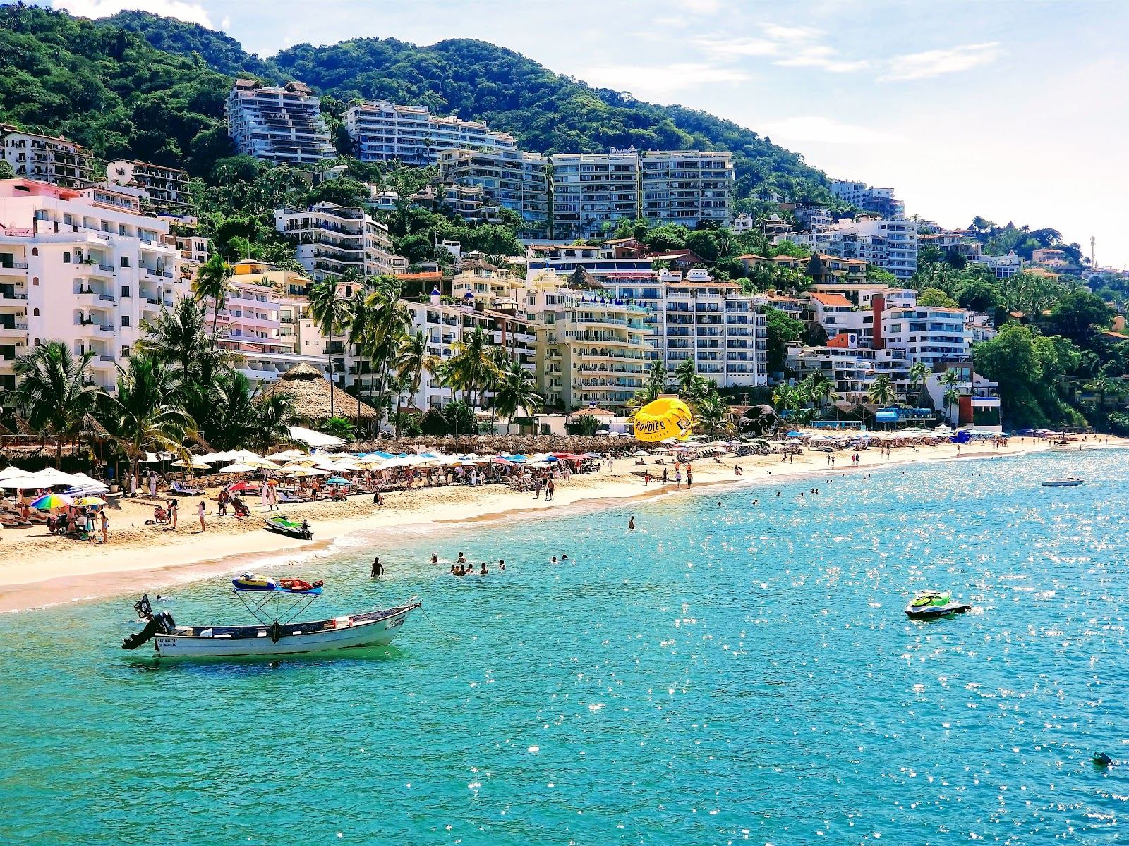 Loungers and lively sand at Playa Los Muertos in the Zona Romantica of Puerto Vallarta