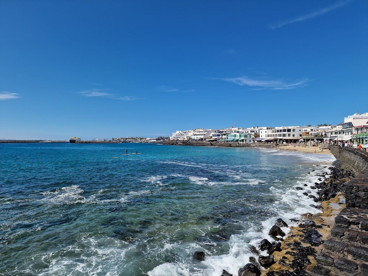 Calm golden town beach and seafront promenade at Playa Blanca in southern Lanzarote