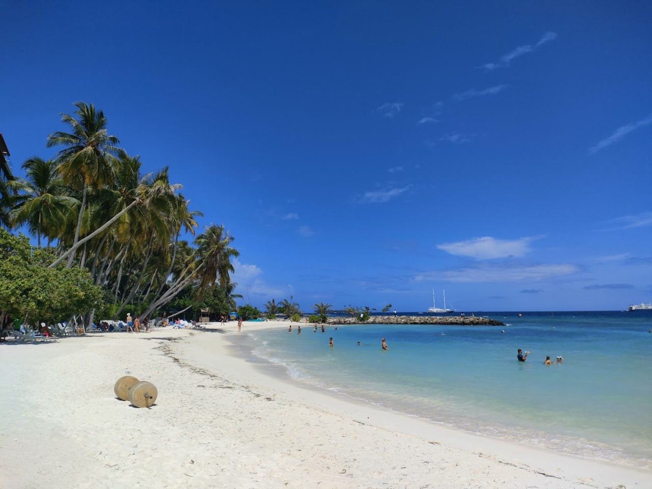 Maafushi Bikini Beach in the Maldives, a bright strip of white sand by a calm lagoon
