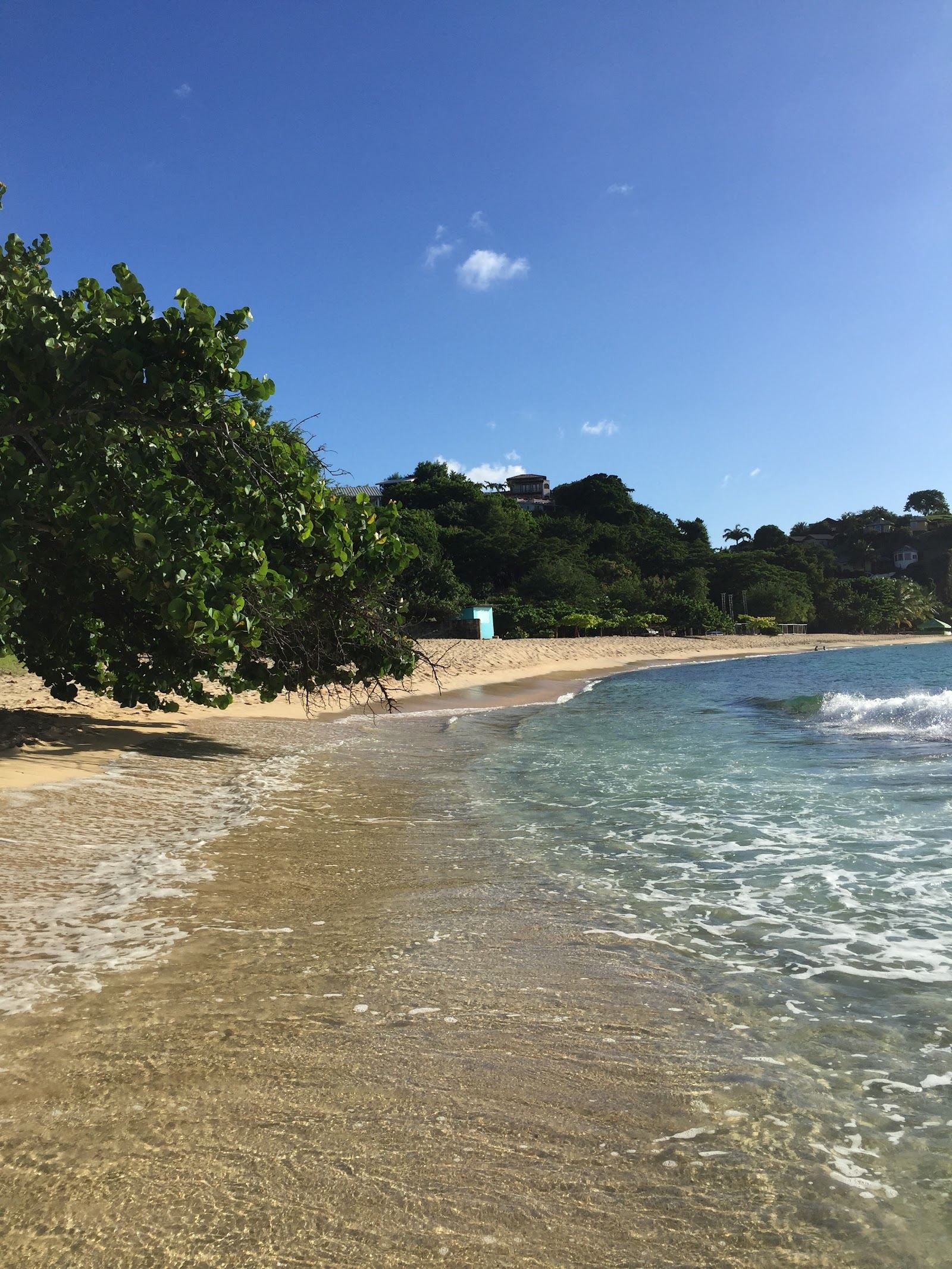 Calm clear turquoise water and soft sand at Magazine Beach near Point Salines in Grenada