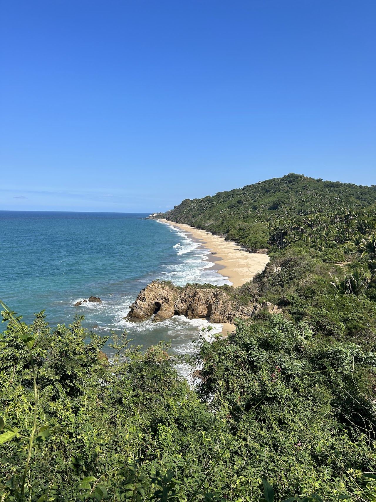 The wide empty sand of Playa Malpaso reached by a jungle trail near Sayulita in Nayarit Mexico