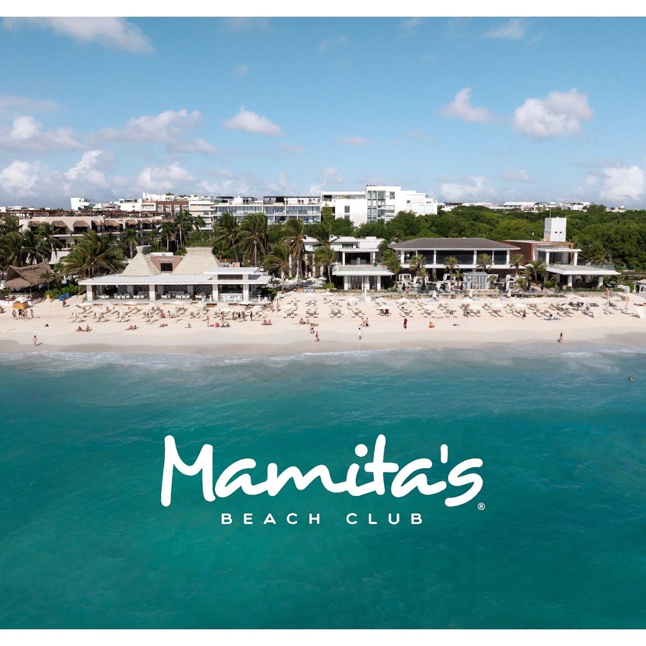 Beach club loungers and turquoise sea along Mamitas Beach in Playa del Carmen