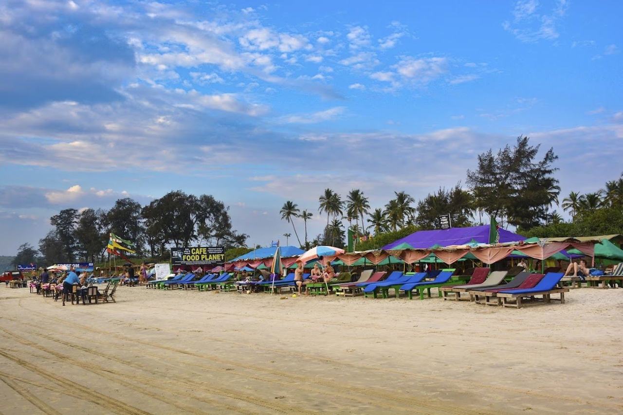 Mandrem Beach wide soft pale sand with calm shallow water in North Goa