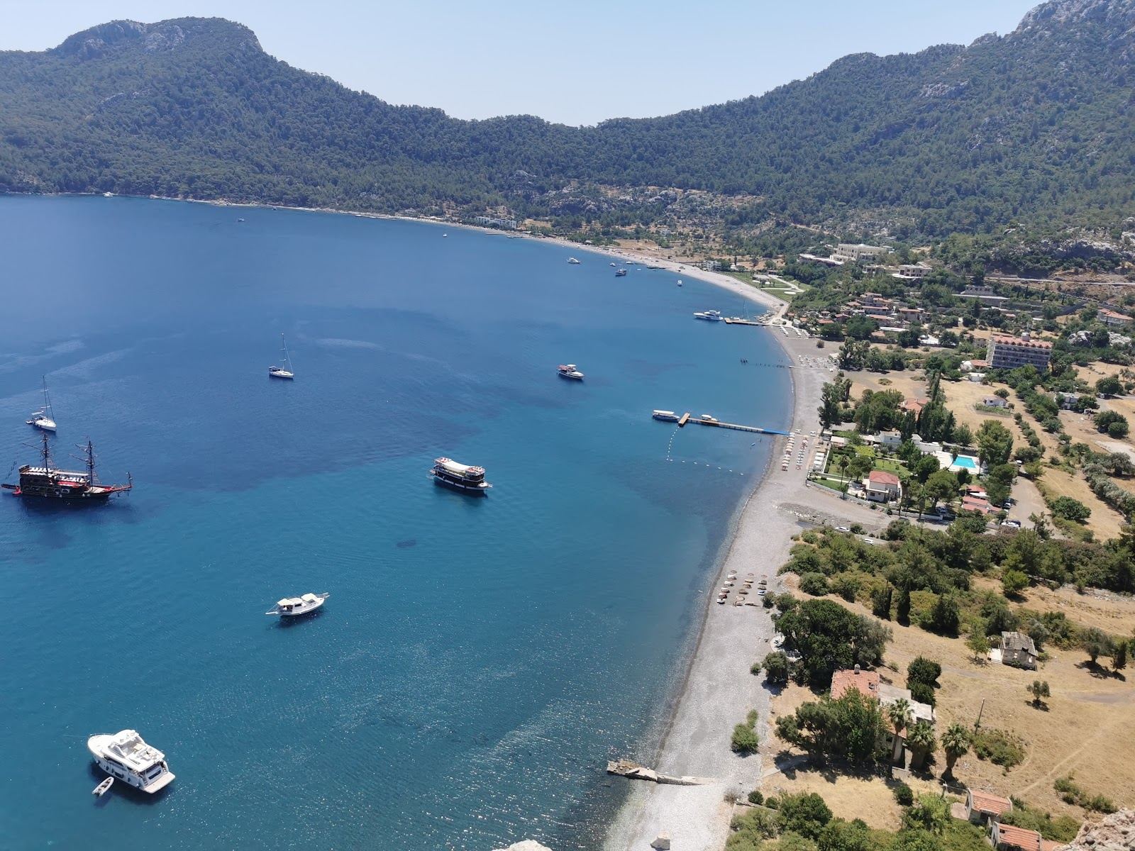 Quiet bay ringed by pine hills with clear water at Kumlubuk south of Marmaris