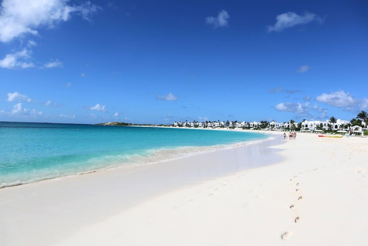 The quiet curving white sand and clear water of Maundays Bay in Anguilla