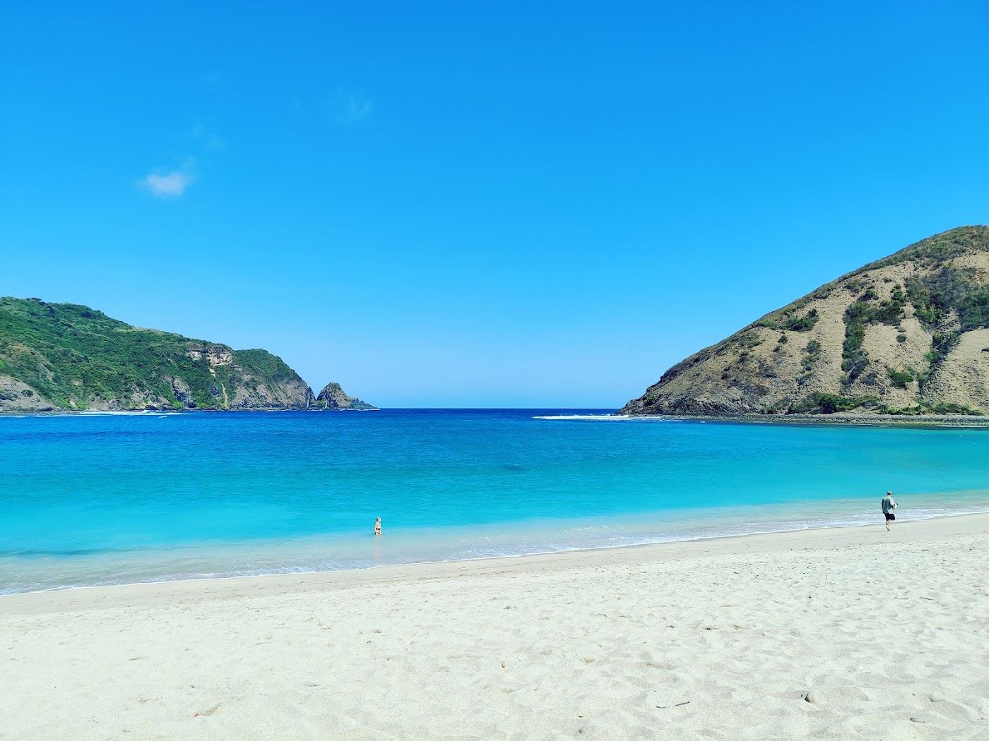 The quiet horseshoe bay and pale sand at Mawun in Lombok