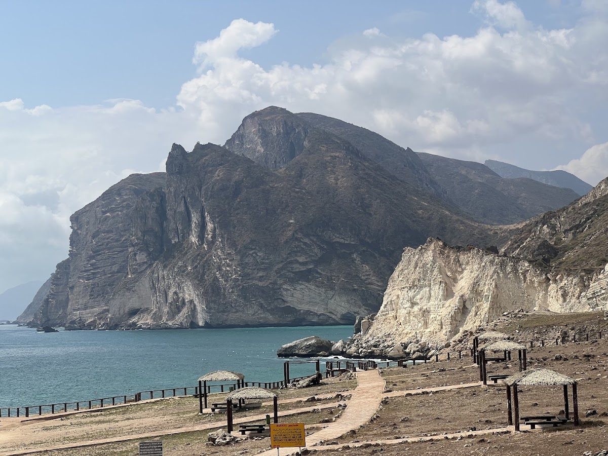 Cliffs and clear water at a beach in Oman