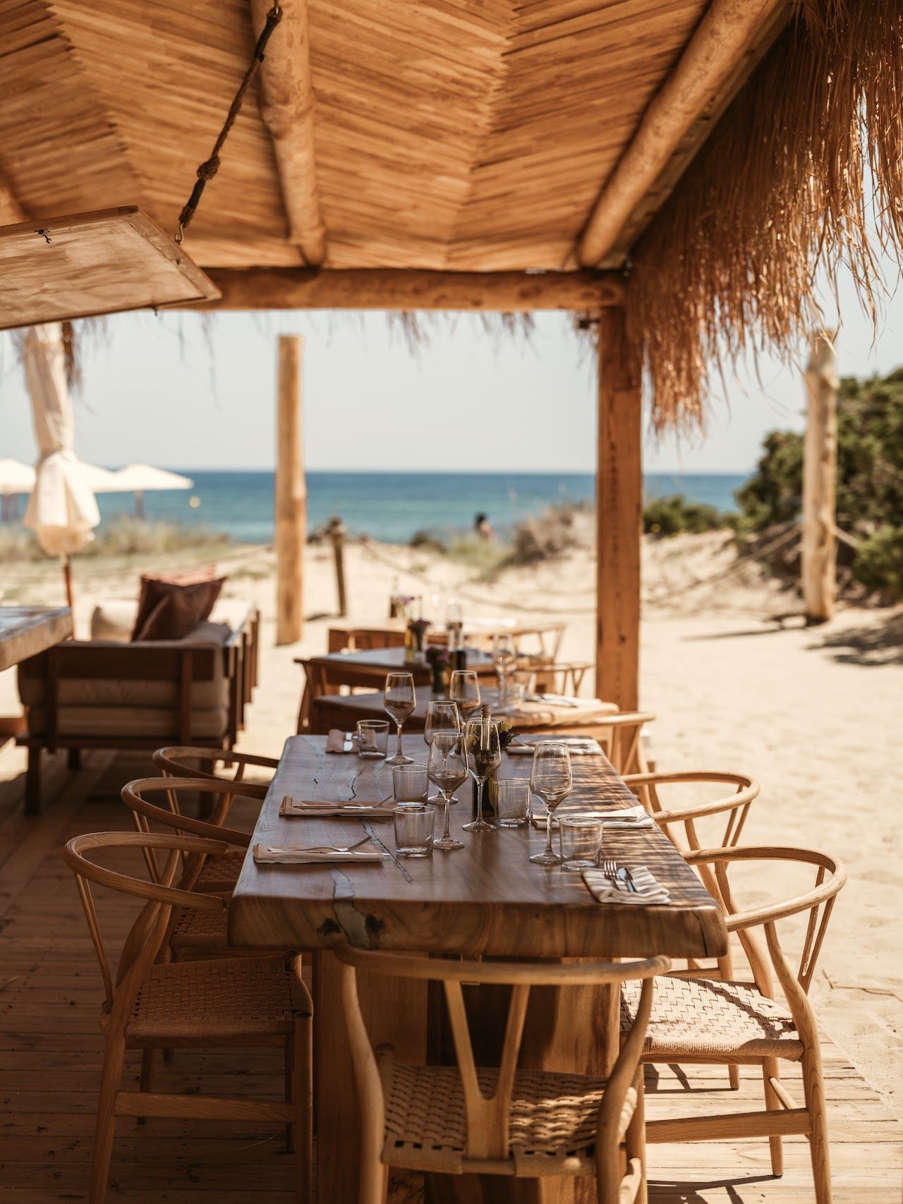 Whitewashed terrace and loungers above the sand at El Chiringuito, Es Cavallet, Ibiza