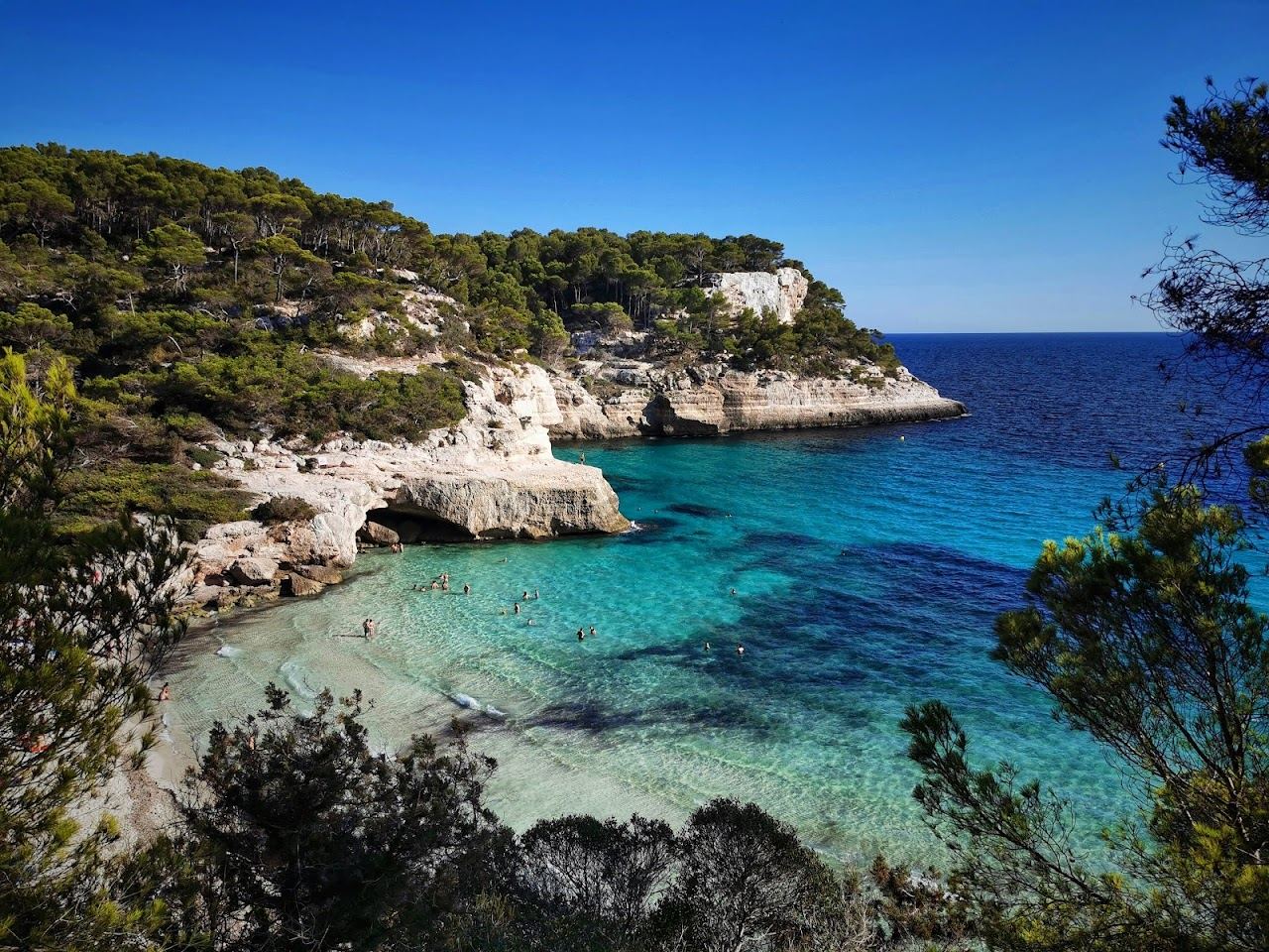 Still clear turquoise water in a sheltered cove on the south coast of Menorca