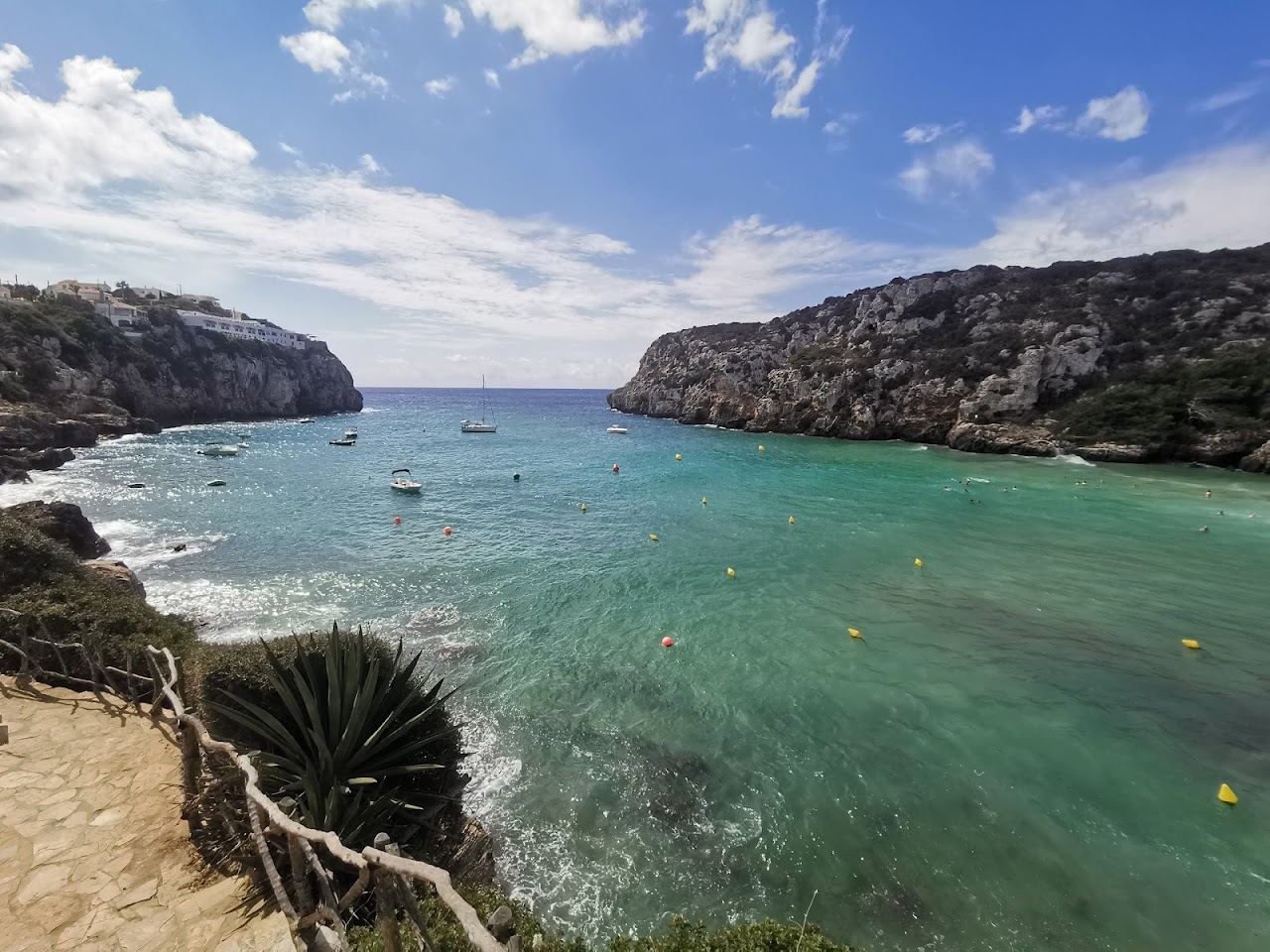 Warm evening light over a sheltered cove at Cala en Porter in Menorca
