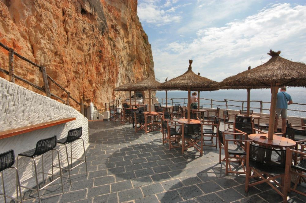 Cliff terrace of the Cova d'en Xoroi cave bar high above the sea at Cala en Porter in Menorca