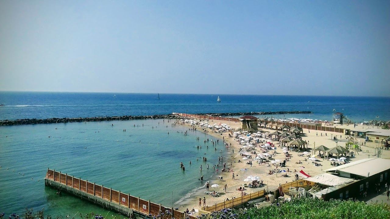 The calm sheltered cove and soft sand of Metzitzim beach by the port in north Tel Aviv