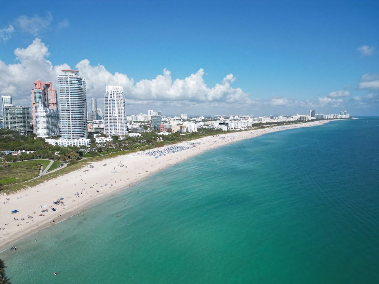 Sunny wide sand and gentle surf at South Beach Miami Beach Florida under a clear sky