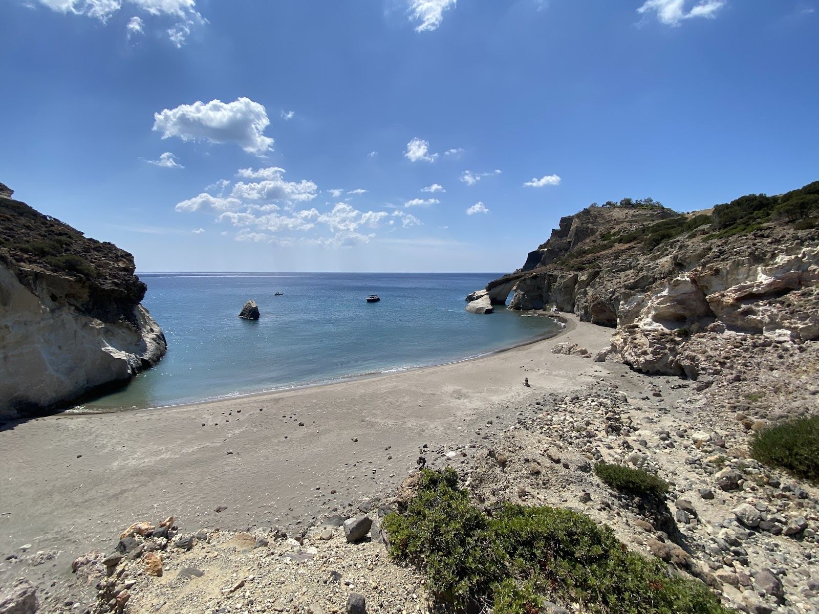 The wild rock arch and quiet clear water of Gerontas cove on the remote southwest coast of Milos