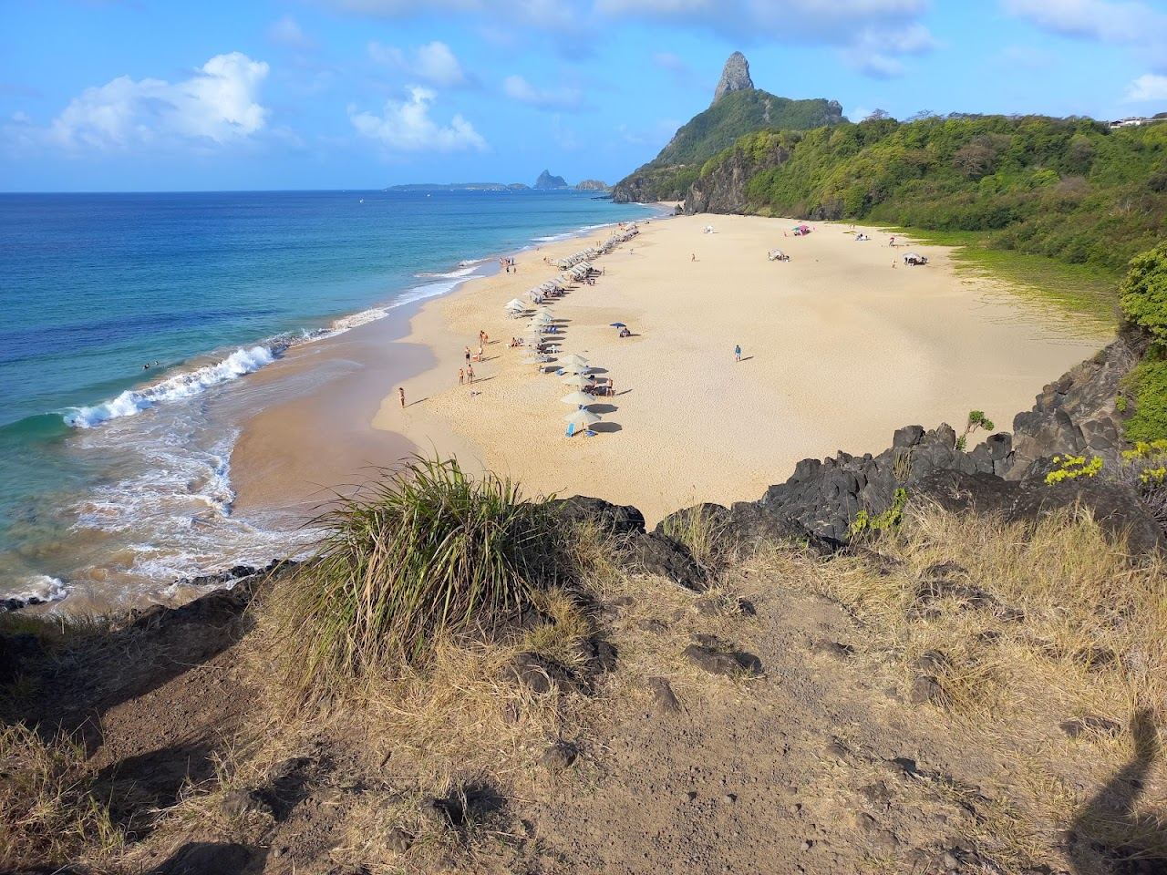 Golden light over the sea at Praia do Bode with the Dois Irmaos rocks in Fernando de Noronha