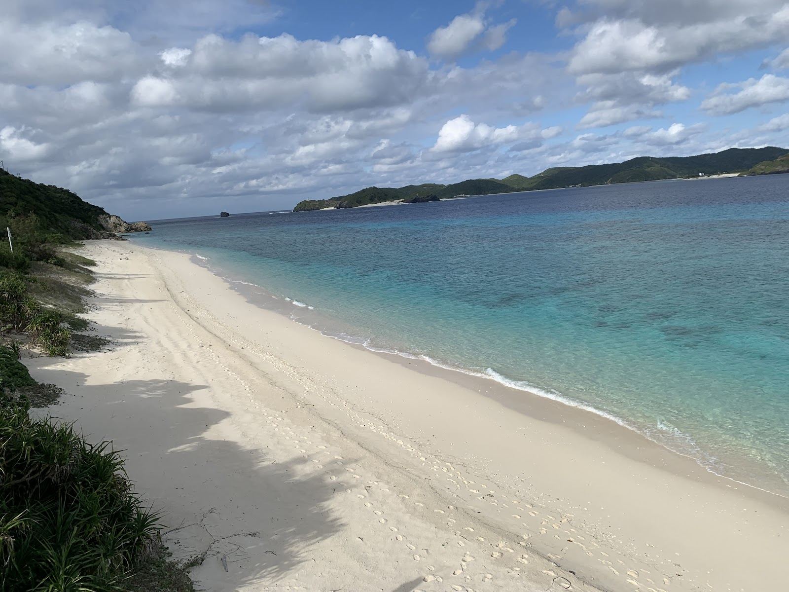 Quiet white sand and clear blue water on a secluded Kerama island beach in Okinawa