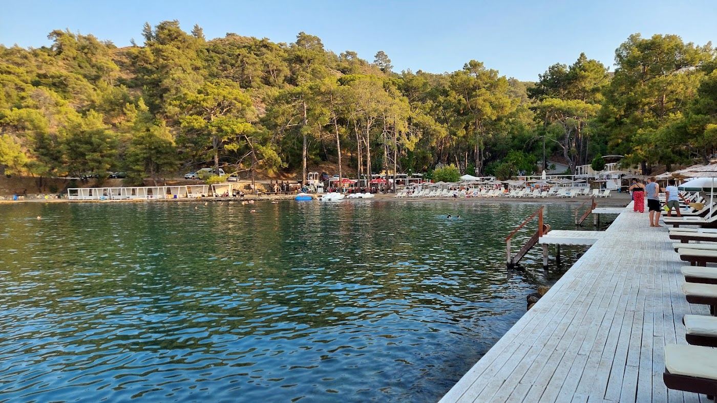 The small calm local bay of Samanlik Beach near Fethiye with clear sheltered water and hills behind in Turkey