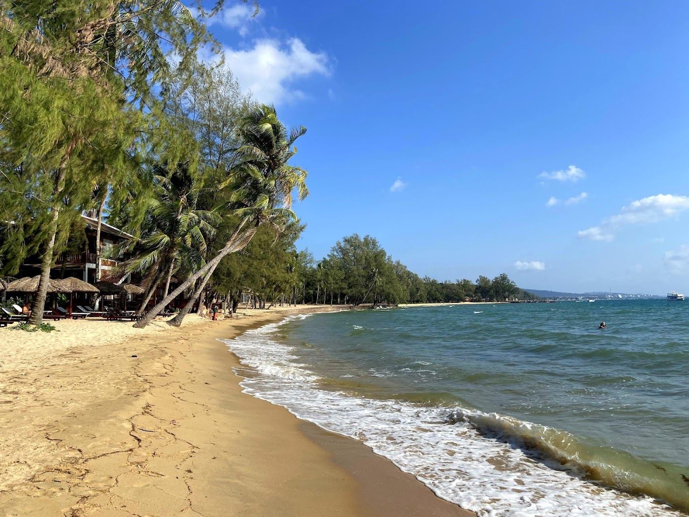 Quiet low rise shore with rocky coves and palms at Ong Lang beach on the west coast of Phu Quoc