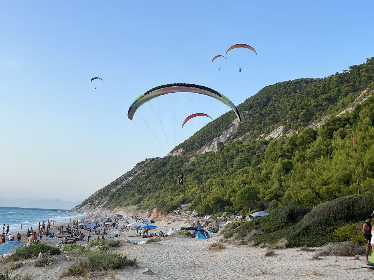 Clear turquoise water meeting the pale sand and gravel of Pefkoulia beach on the Lefkada west coast