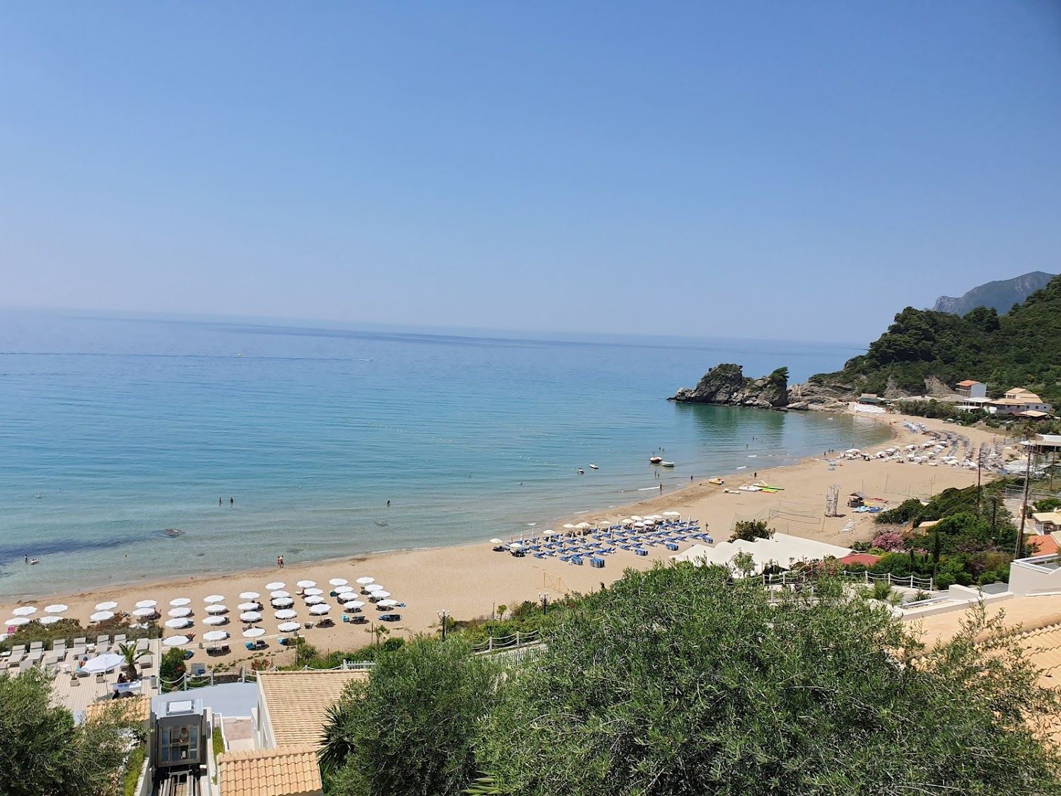 Broad golden sand and open Ionian water at Kontogialos beach below Pelekas in west Corfu