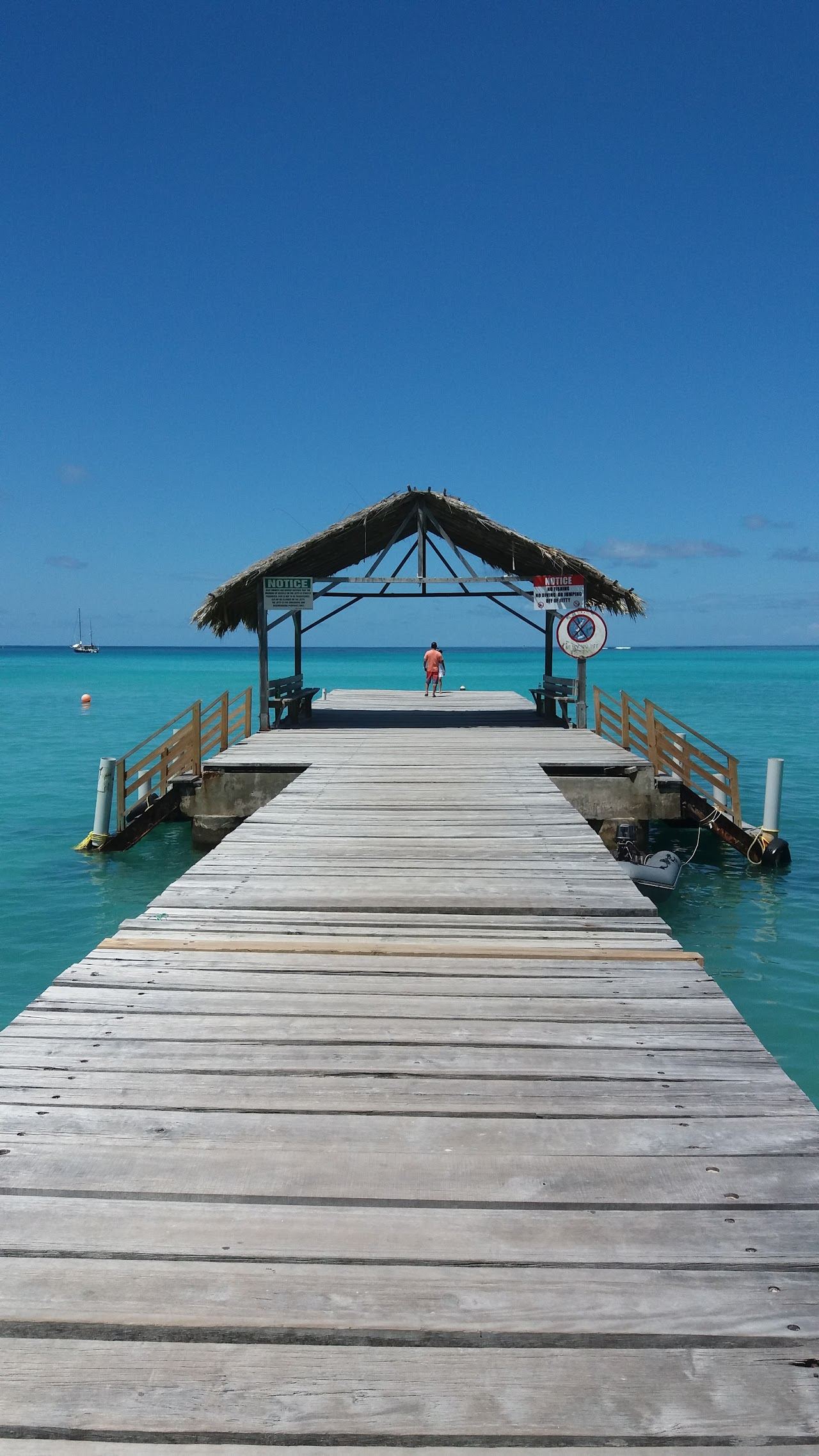 Calm shallow turquoise water and the thatched jetty at Pigeon Point used for the Tobago watersports guide on Beaches for Kings
