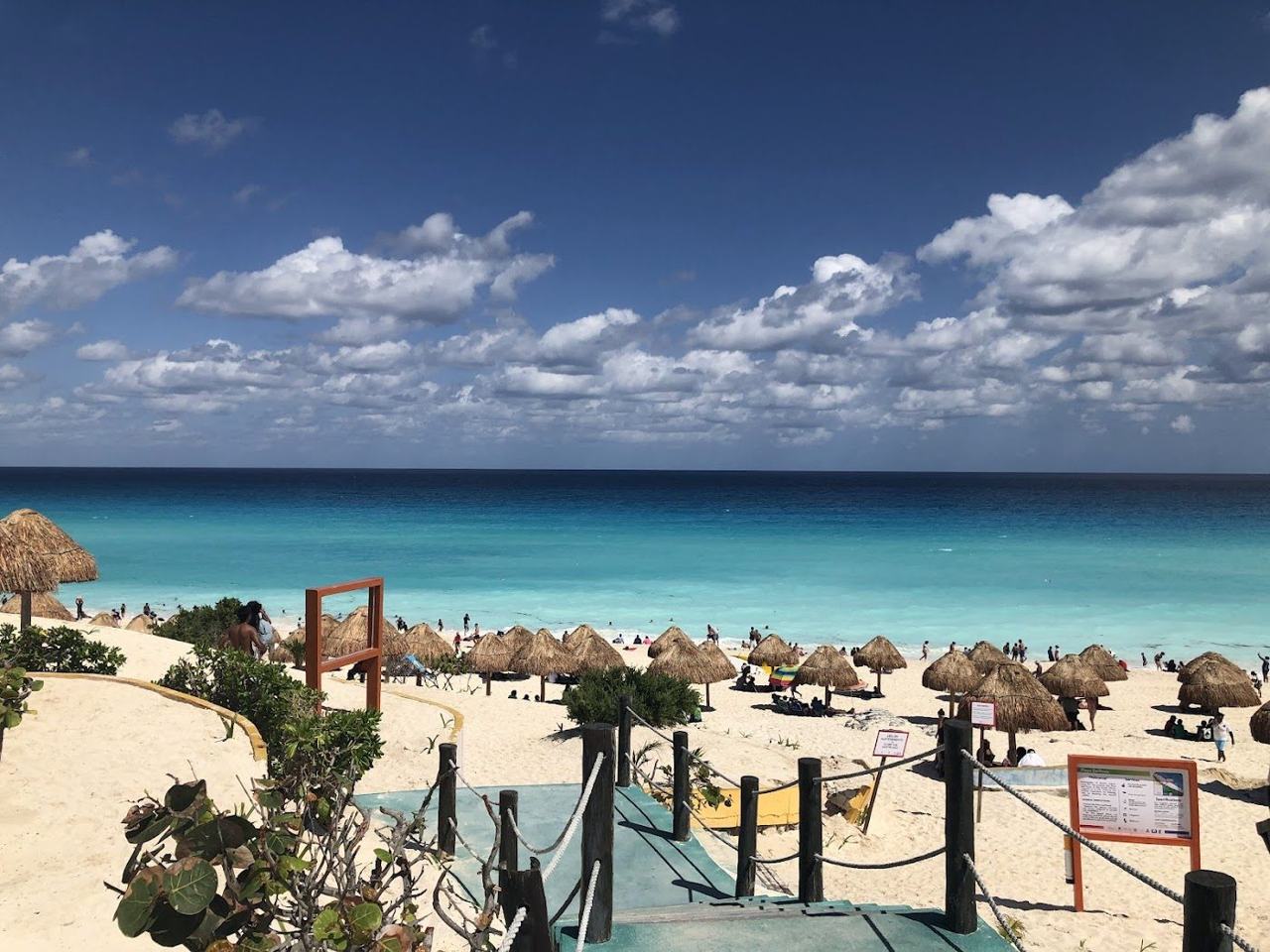 Wide white sand and turquoise Caribbean water at Playa Delfines in the Cancun hotel zone