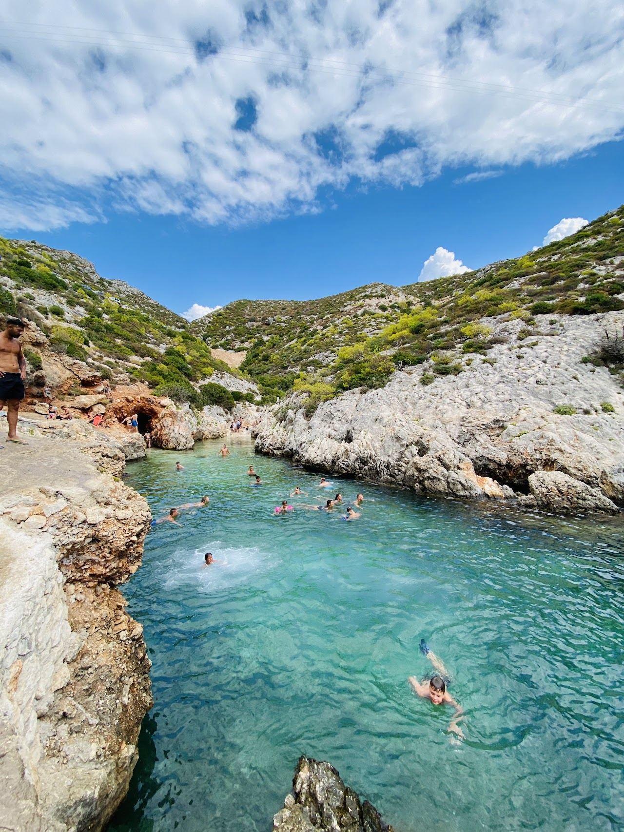 Deep clear turquoise water in the narrow rocky inlet of Porto Limnionas on the west coast of Zakynthos