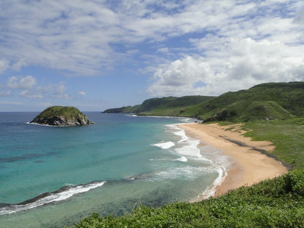The wild golden sand and lion shaped rock at Praia do Leao on Fernando de Noronha