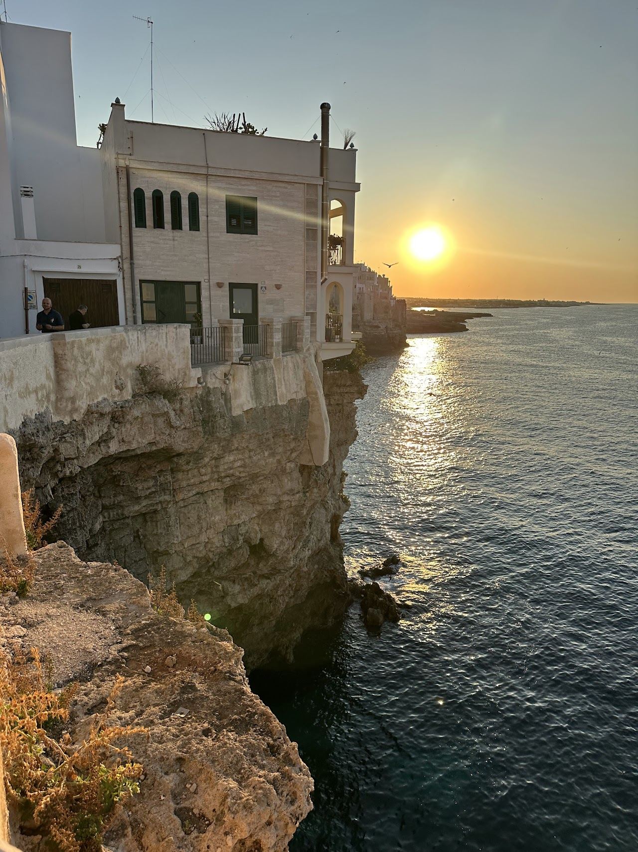 The white old town of Polignano a Mare on limestone cliffs above the clear Adriatic in Puglia