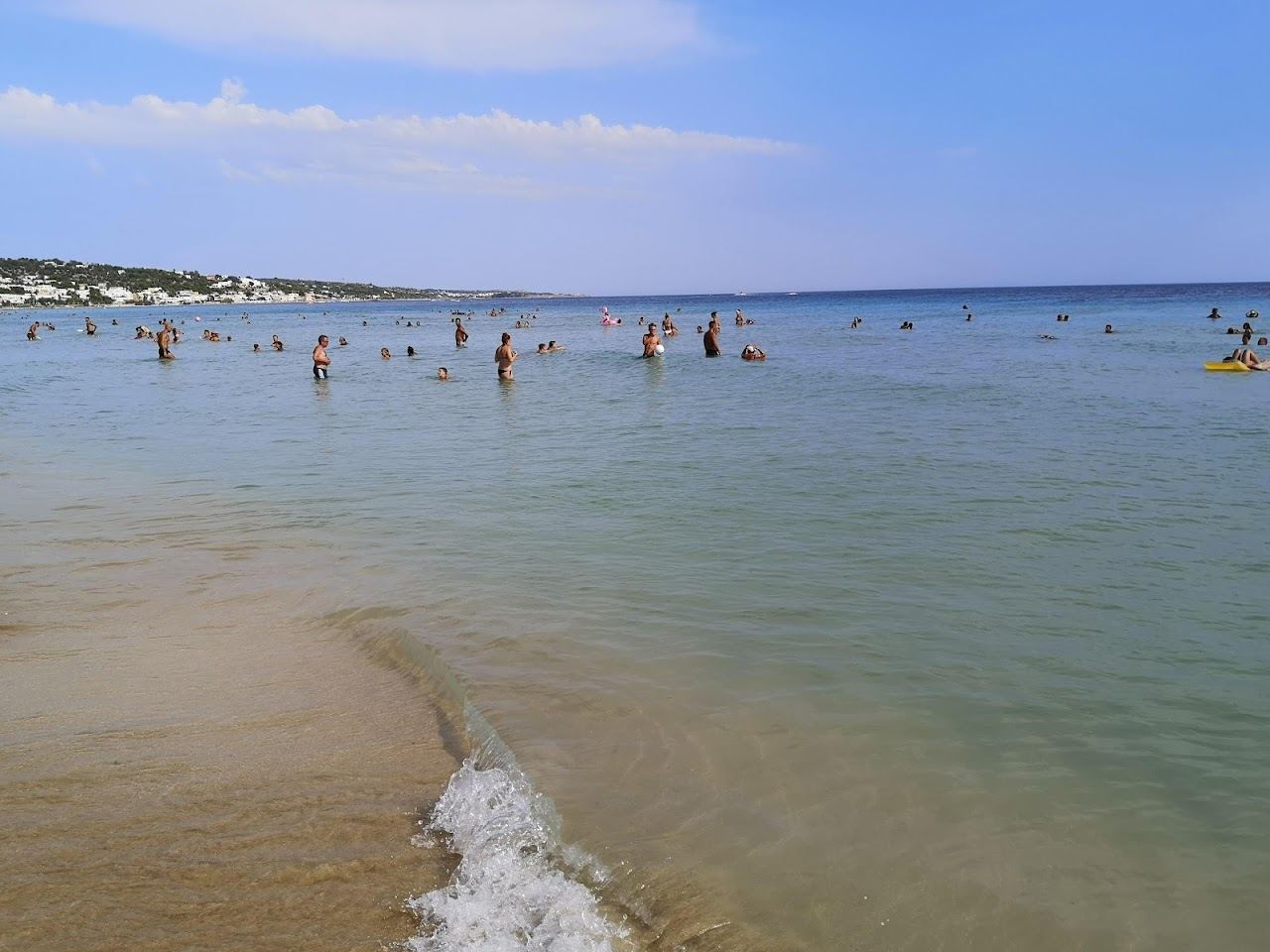 Pale sand and shallow turquoise water on Pescoluse beach in the Salento