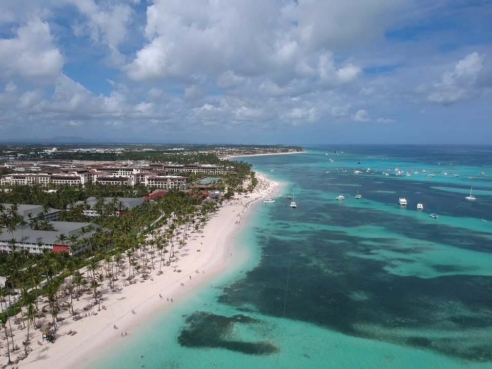 Calm shallow turquoise water and pale sand at Bavaro beach in Punta Cana in the Dominican Republic