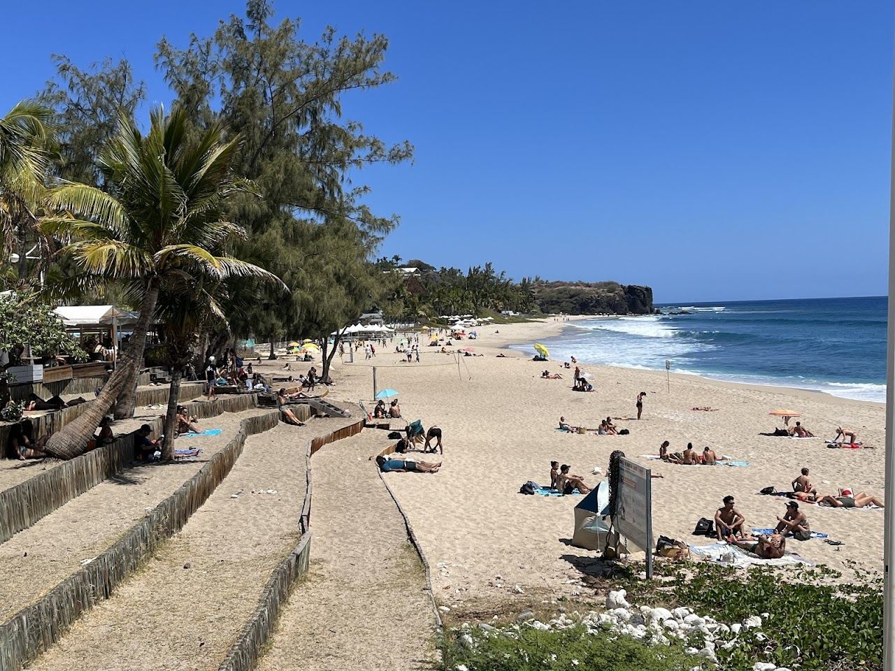 Beachfront restaurants and white sand along the esplanade at Boucan Canot in Reunion