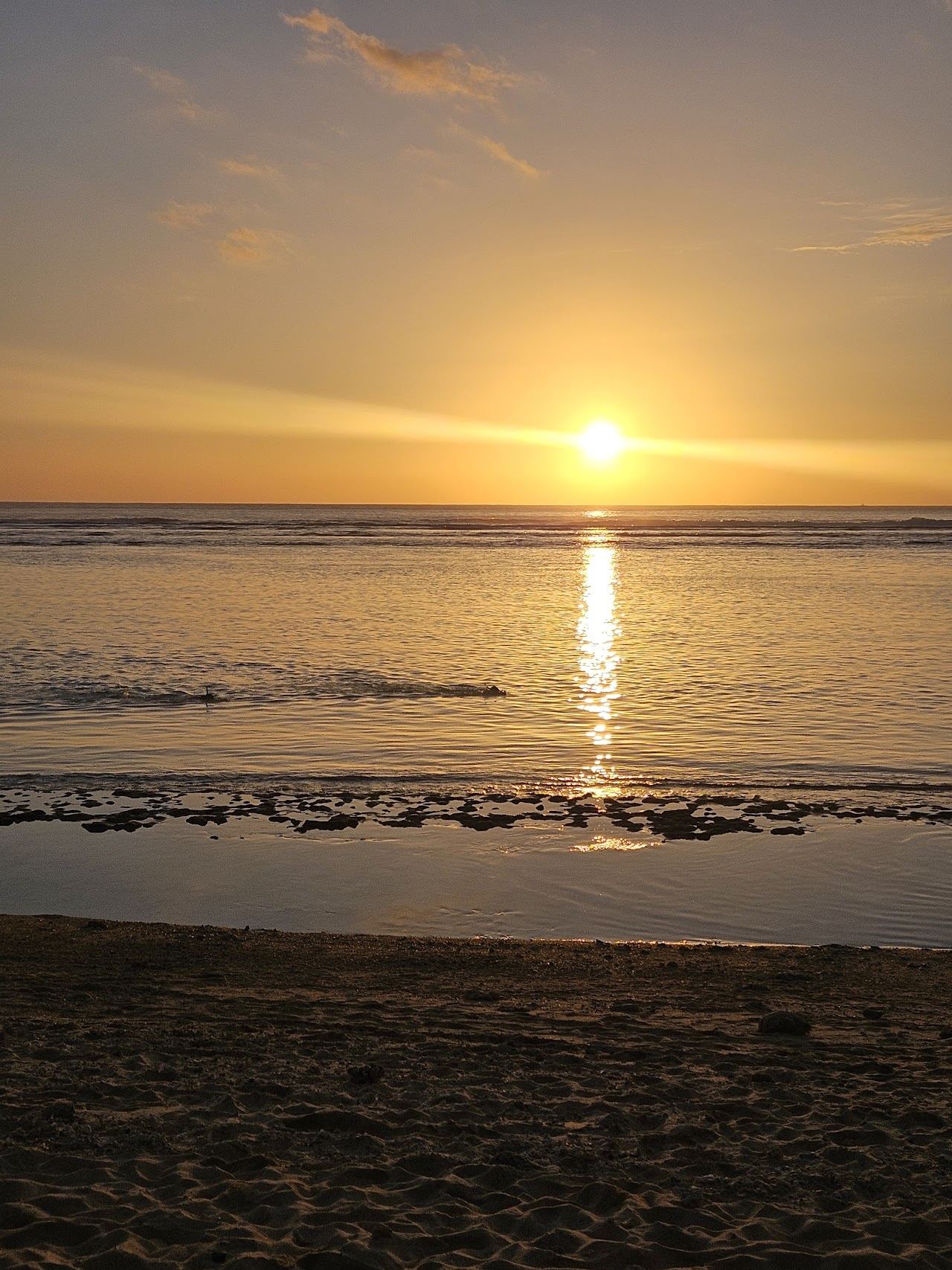 Calm shallow reef lagoon and white sand under filao pines at L'Hermitage on the west coast of Reunion
