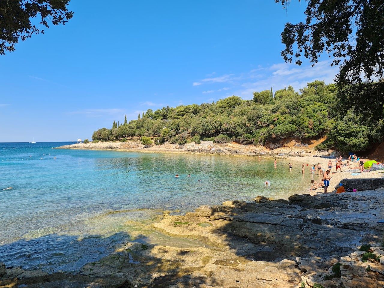 Clear water and pebble shore at Saccorgiana bay on the Verudela peninsula near Pula in Istria