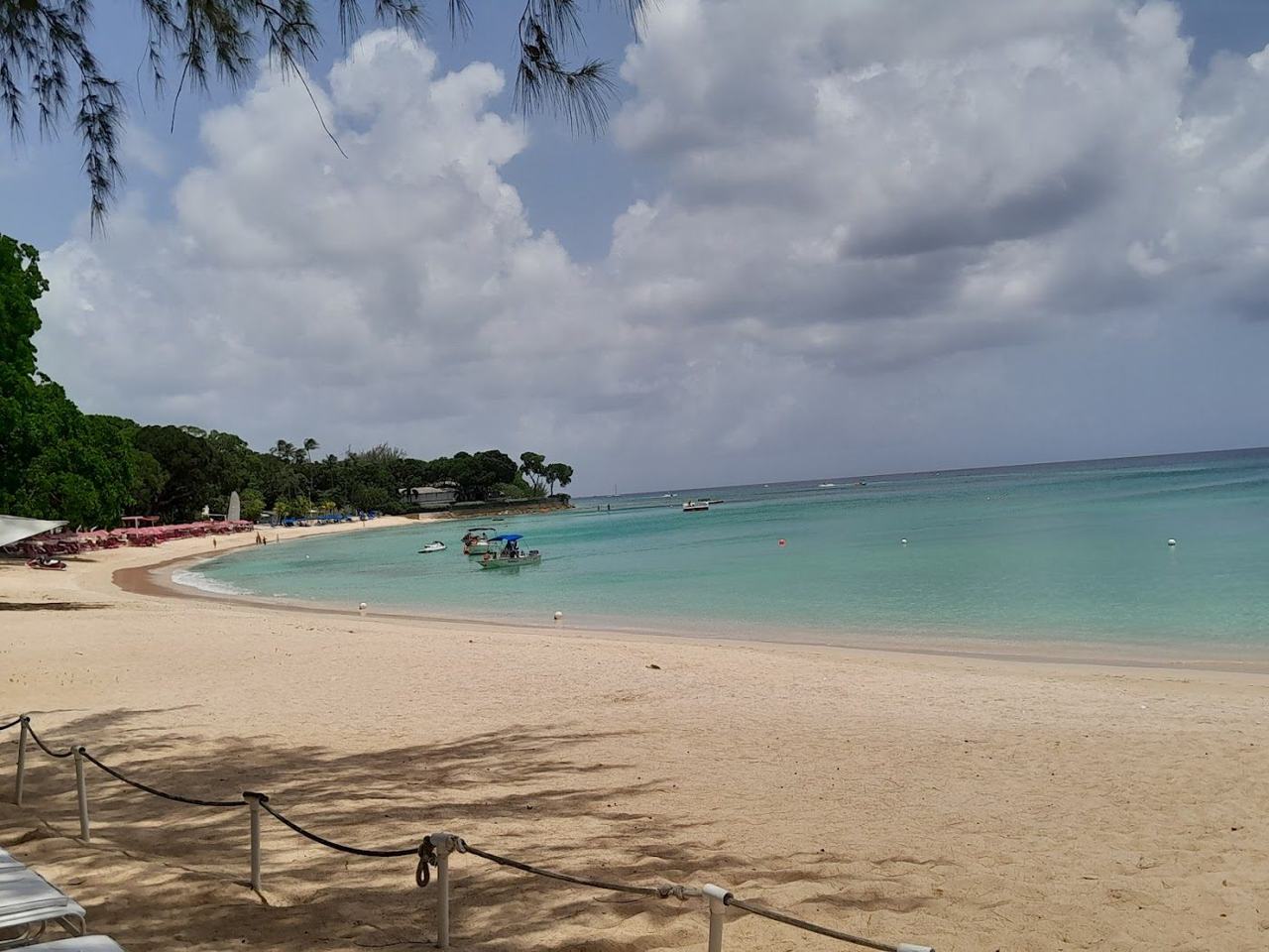 Calm turquoise Caribbean water and pale sand on Sandy Lane Beach on the west coast of Barbados