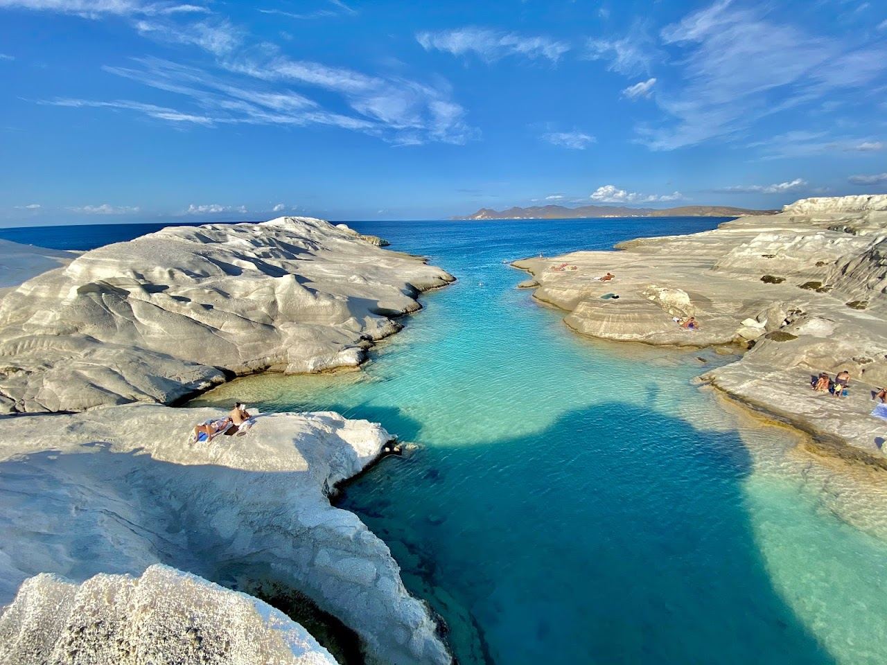 The white volcanic rock ledges and clear inlet of Sarakiniko with no sunbeds or beach bar on the north coast of Milos