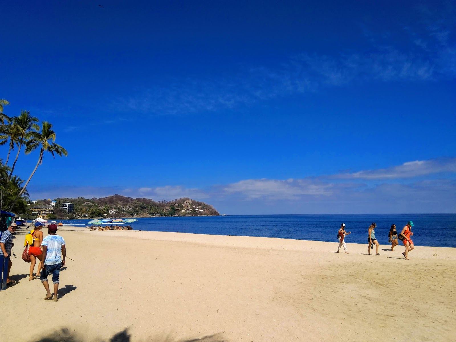 Soft golden sand, surfers and palapa restaurants on the main beach at Playa Sayulita in Nayarit Mexico