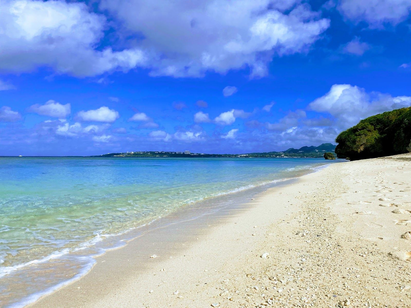 The natural white coral sand and clear reef water of Sesoko Beach off the Motobu Peninsula in Okinawa