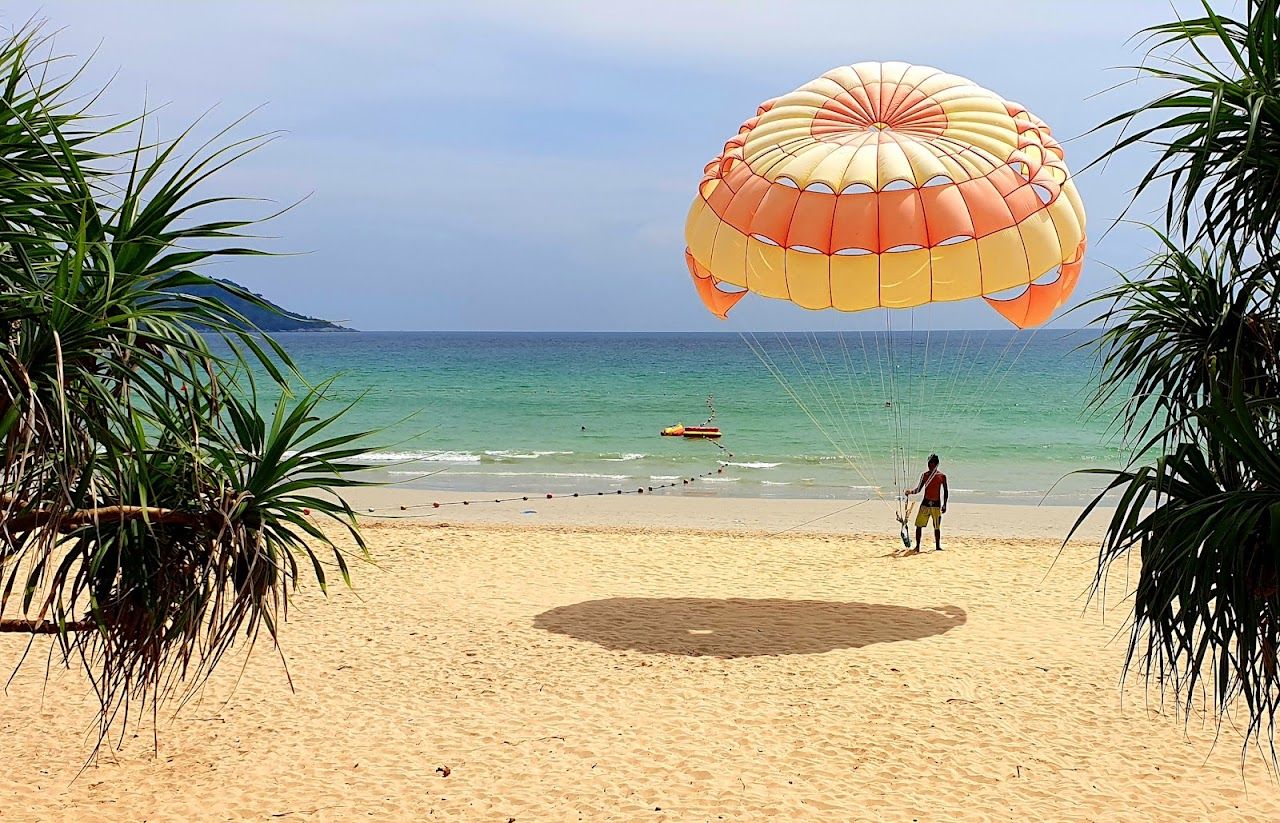 Palm backed sand and clear water at Kata Beach, Phuket, Thailand