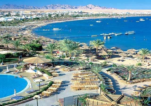 Soft pale resort sand and clear blue water at a groomed bay in Sharm El Sheikh on the Red Sea
