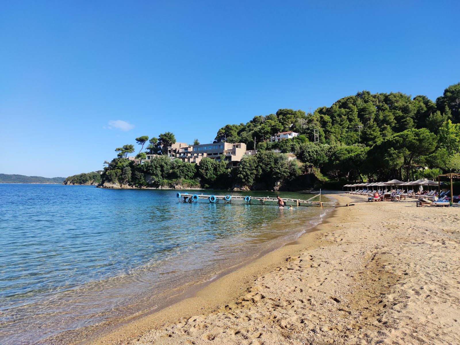 Calm clear water in the sheltered cove of Tzaneria beach on the Kanapitsa peninsula of Skiathos