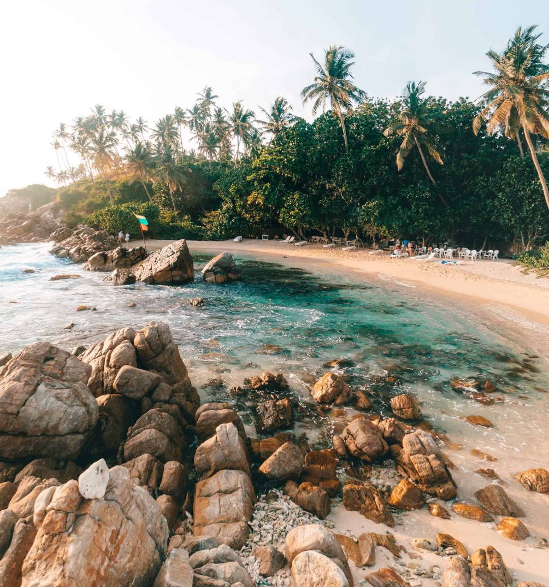 The crescent bay and palm backed sand of Mirissa on the south coast of Sri Lanka