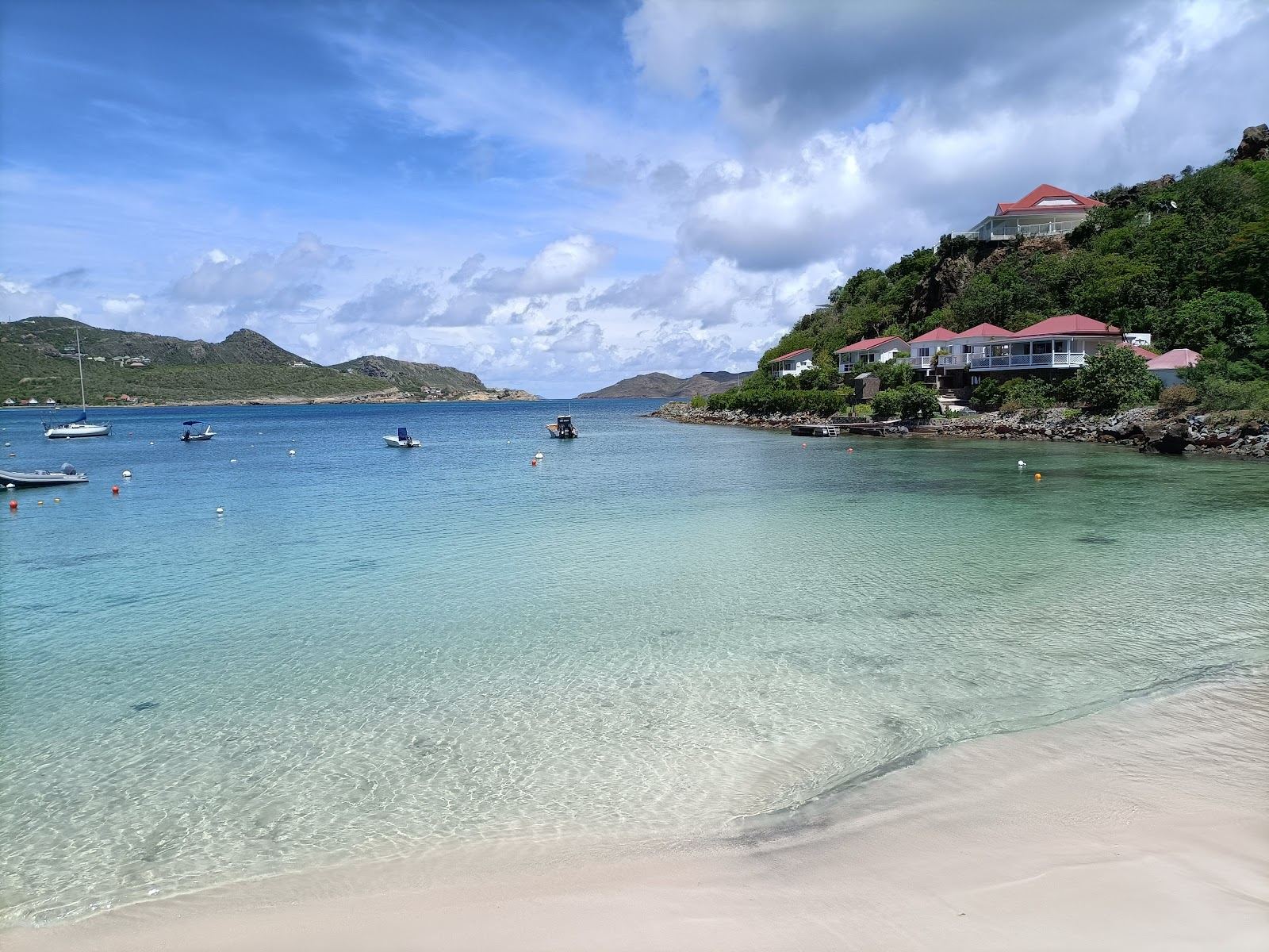 A calm reef sheltered bay with shallow clear water at St Jean in St Barths