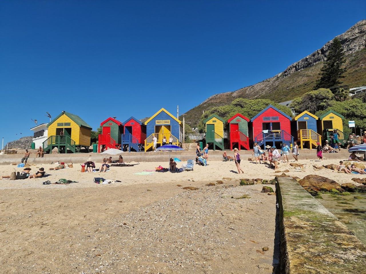 St James Beach tidal pool and colourful bathing boxes on the False Bay shore in Cape Town