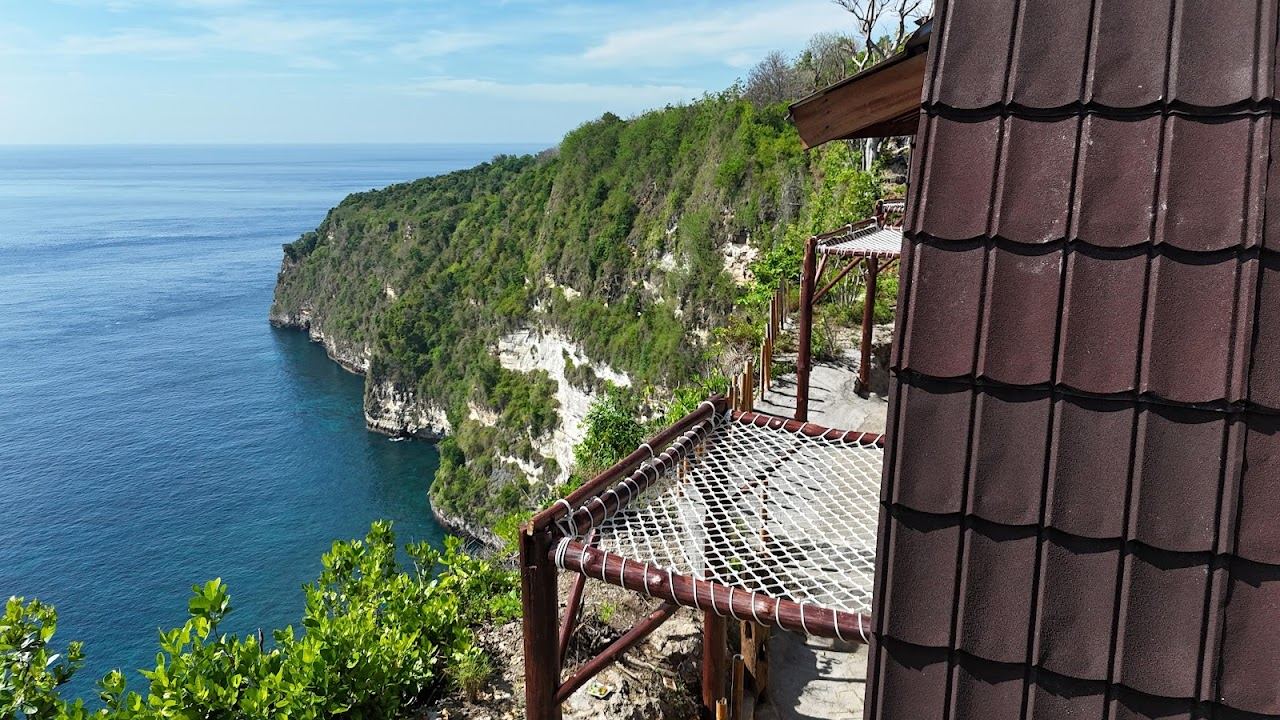 The pyramid rock and pale sand of Suwehan Beach seen from the cliff path on Nusa Penida