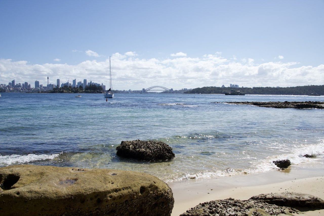The hidden harbour sand and city skyline view at Milk Beach in Sydney
