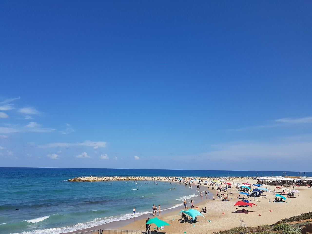 Calm sheltered water behind a breakwater on a Tel Aviv swimming beach