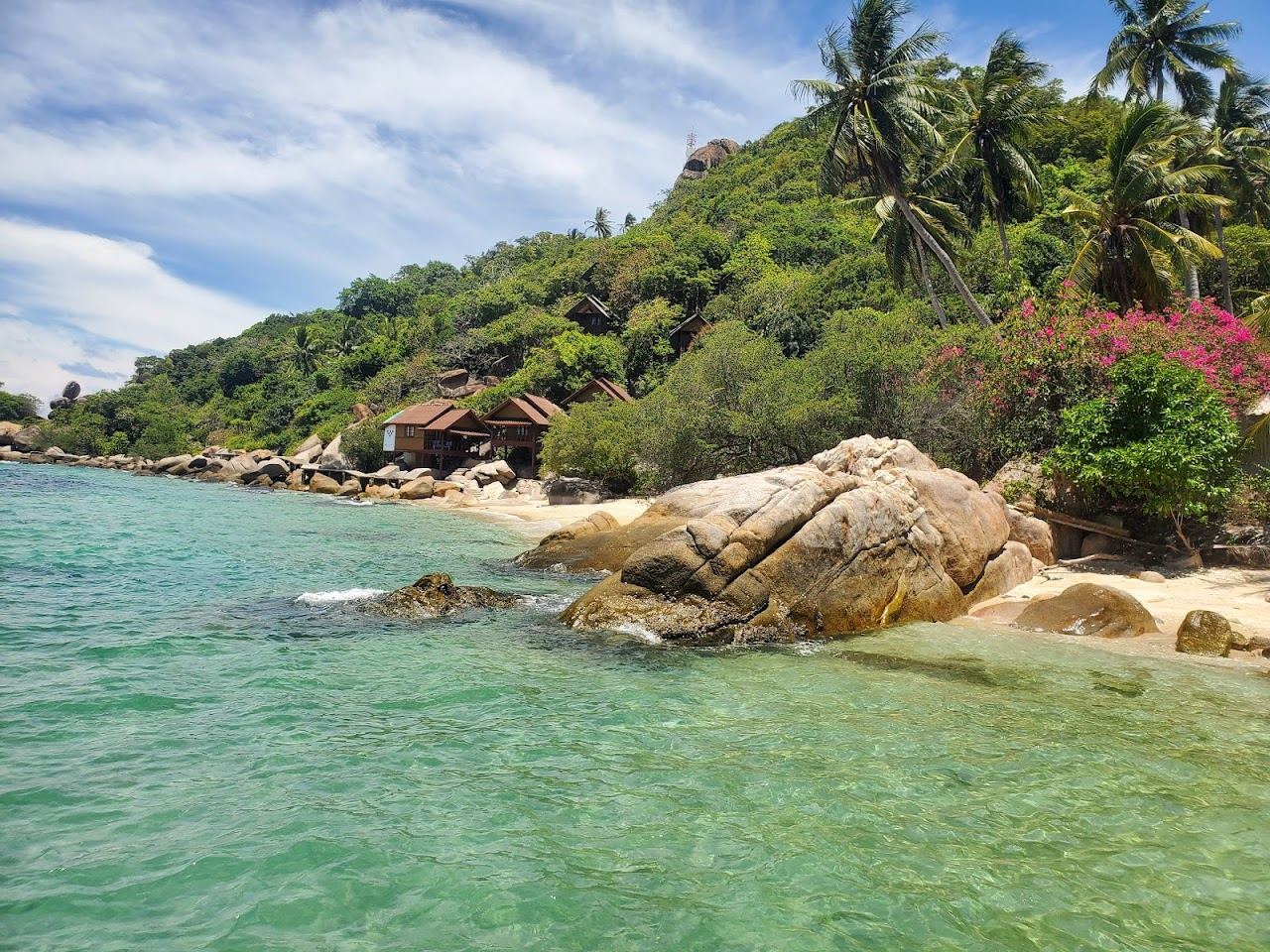 Quiet clear water and granite rocks at the remote June Juea Bay on southwest Koh Tao